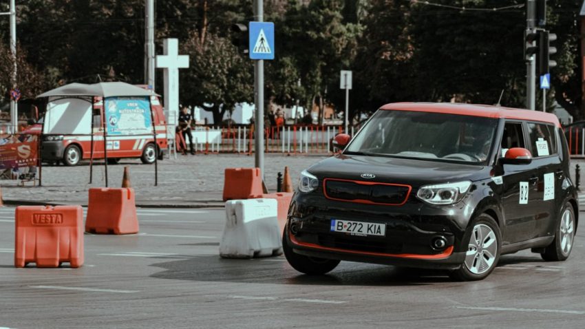 Black car driving fast and turning in drift while taking part in urban rally racing